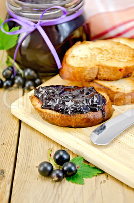 Bread with black currant jam on the board