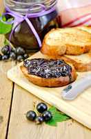 Bread with black currant jam on the board