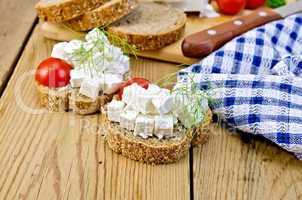 Bread with feta and tomatoes on board with napkin