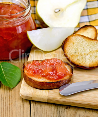 Bread with pear jam and leaf on board