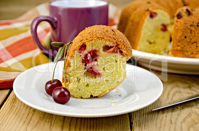 Cake with cherries and plate on board