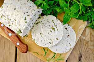 Cheese homemade with herbs and knife on board