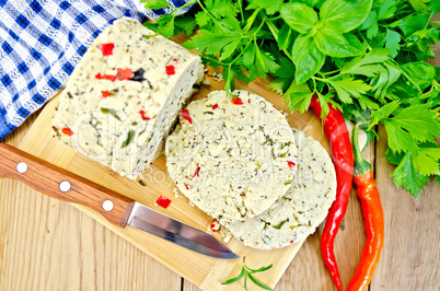 Cheese homemade with hot pepper and knife on board