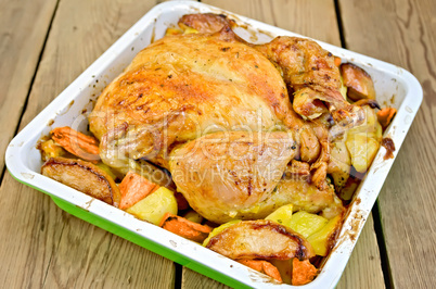 Chicken baked with vegetables on board