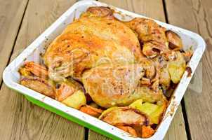 Chicken baked with vegetables on board