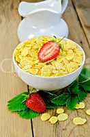 Cornflakes with strawberries and milk on board