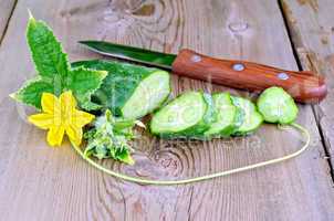 Cucumber sliced with flower and leaf on board