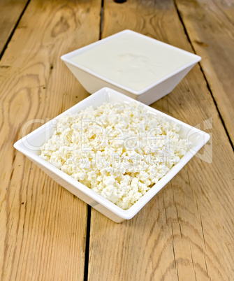 Curd and sour cream in bowls on board