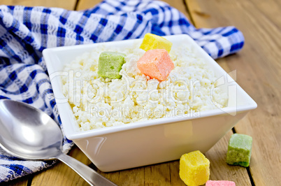 Curd with colored sugar and spoon on board