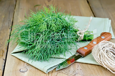 Dill with napkin and twine on board