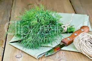 Dill with napkin and twine on board