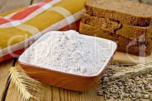 Flour rye in bowl with bread on board