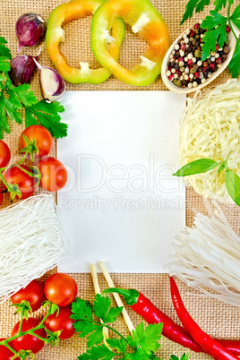 Frame of vegetables and funchozy with paper on sackcloth