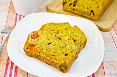 Fruitcake pumpkin with candied fruit on plate and napkin