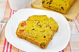 Fruitcake pumpkin with candied fruit on plate and napkin