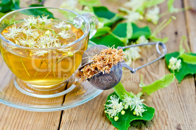 Herbal tea from linden flowers with strainer on board