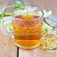 Herbal tea from meadowsweet dry in mug with strainer