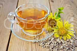 Herbal tea from root of elecampane with flower on board