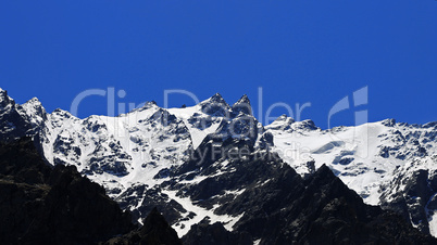 Caucasus mountains under snow and clear blue sky