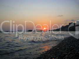 Sunset over summer sea with a small waves