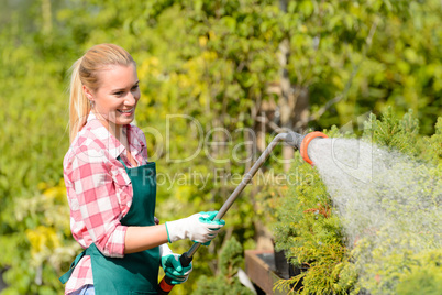garden center woman watering plants with hose