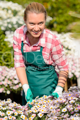 garden center woman in flowerbed smiling