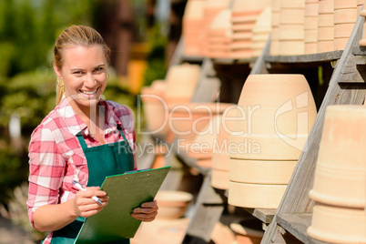 garden center woman standing by clay pots