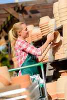 garden center woman with clay pots cart