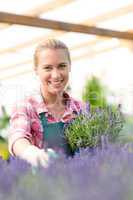 garden center woman with lavender flowers smiling