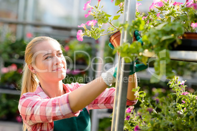 female garden center worker with potted flowers