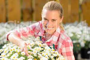 smiling garden center woman potted daisy flowers
