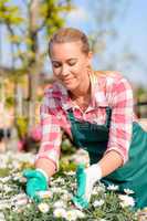 garden center woman worker caring for flowers
