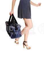 Woman's legs with bag.