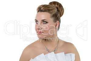 Woman in white wedding dress looking up