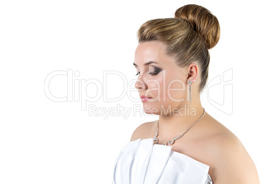 Woman in white wedding dress looking down