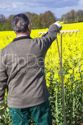 Farmer with hand tools in the field