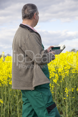 Farmer with calculation engine in the rape field