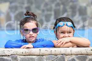 Portrait of two little girls in the pool