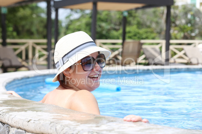 Beautiful woman smiling in the pool
