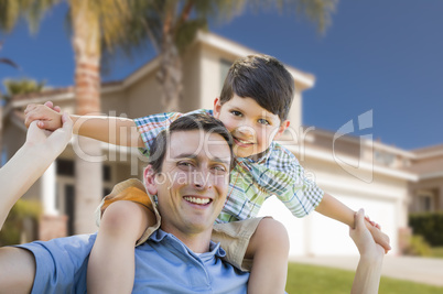 Mixed Race Father and Son Piggyback in Front of House