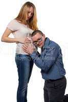 Young man listening woman's tummy