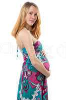 Pregnant woman with tummy standing in dress