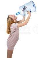 Funny pregnant woman drinking from bottle