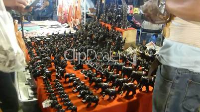 Stall selling hand-carved wooden elephants at night bazaar, Chiang Mai, Thailand