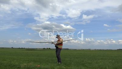 Man Launches RC Glider in the Sky, on blue sky background