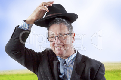 Man lifts hat in greeting