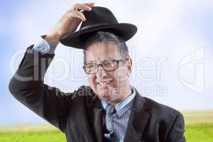 Man lifts hat in greeting