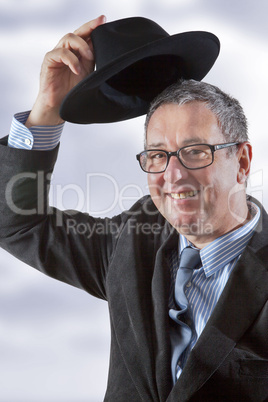 Man lifts hat in greeting