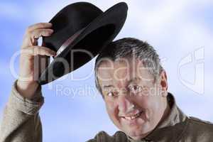Man lifts hat in greeting