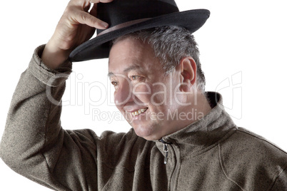 Man lifts hat in greeting